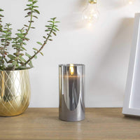 12 x Brand New Festive Lights 15cm real wax LED candle in a smoked glass cylinder - Authentic flickering flame on a realistic black wick - Battery operated with timer - RRP €114.0