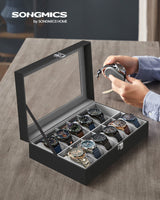 1 x RAW Customer Returns SONGMICS Watch Box with 12 Compartments, Watch Case, Glass Lid, Watch Case with Removable Watch Cushions, Premium Watch Box, PU Cover in Black, Velvet Lining in Green-Gray JWB12BK - RRP €25.99